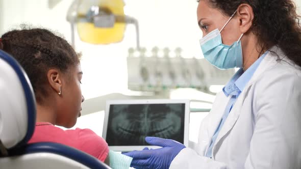 Stomatologist Showing Dental Xray to Girl Patient