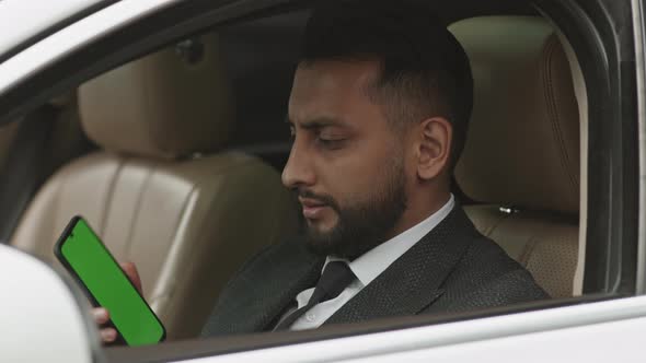 Professional Driver Posing with Green-screened Smartphone