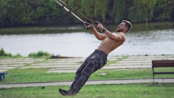 Man doing exercise outdoors. Fit young man exercising in park