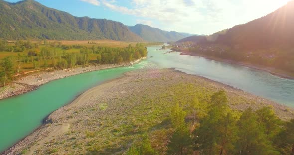 Low Altitude Flight Over Fresh Fast Mountain River with Rocks at Sunny Summer Morning