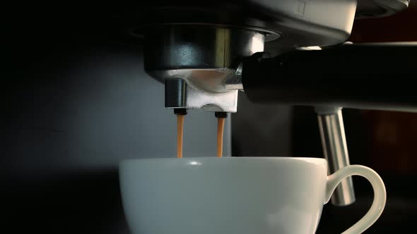 Pouring Coffee Stream From Machine in Cup