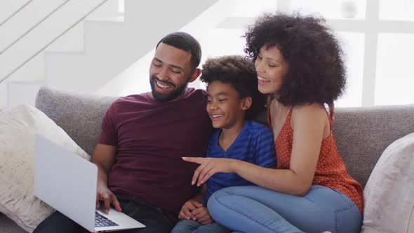 Family having a video call on a laptop at home