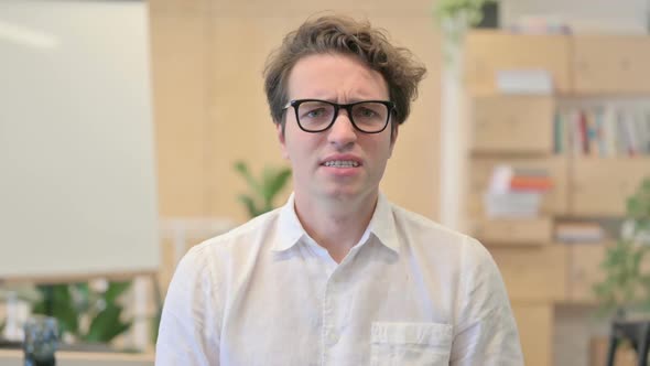 Portrait of Attractive Young Man Screaming Shouting