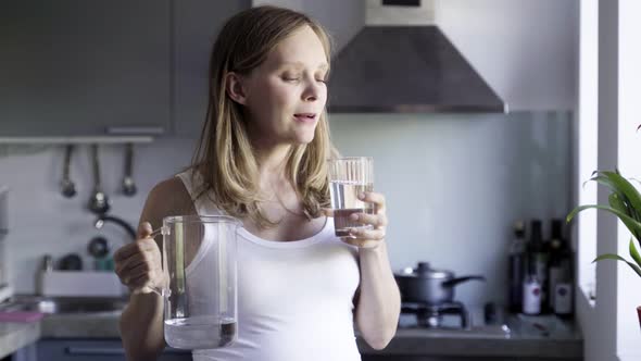 Calm Beautiful Woman Drinking Water From Glass