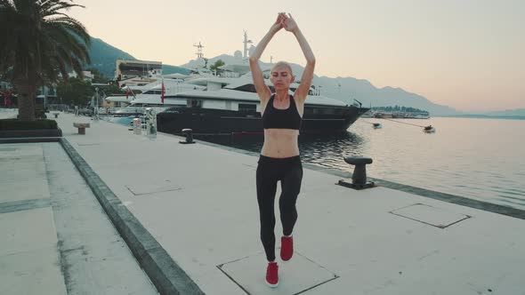 Woman Practising Sport Exercises Outdoor on the Quay