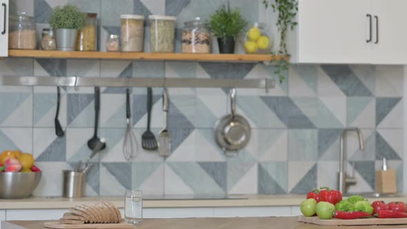 Attractive Young Man Coming and Standing in Kitchen