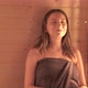 Young Girl Sitting in the Sauna with Closed Eyes - VideoHive Item for Sale