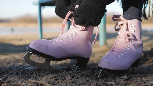 Young Woman Ice Skating on a Frozen Lake on a Freezing Winter Day. Legs of Skater on Winter Ice Rink