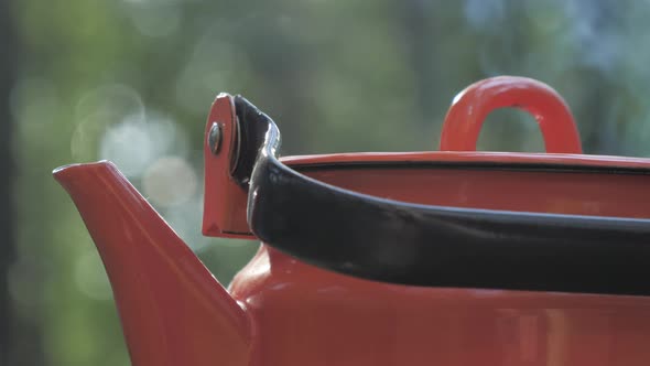 The Top of the Red Coffee Pot on the Stove