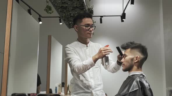 Asian Male Is Getting a Modern Haircut in Barber Shop