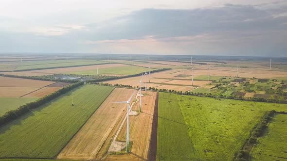 Aerial view of wind turbine generators in field producing clean ecological electricity.