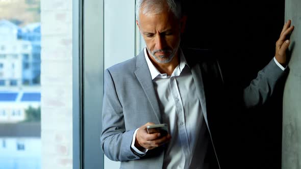 Businessman using mobile phone in hotel room 4k