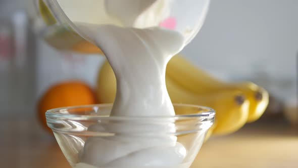 the Pastry Chef Puts the Whipped Cream in a Transparent Glass Bowl