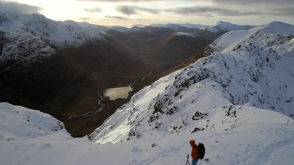 Mountaineer on the Summit of a Snowy Mountain