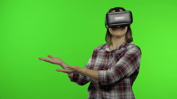 Young Woman Using VR Headset Helmet To Play Game, Showing Side Advertising Area. Chroma Key
