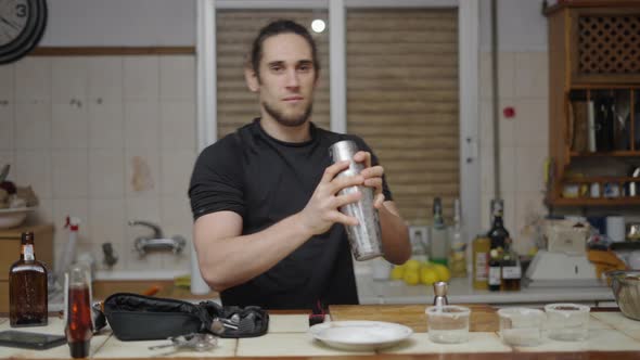 Barman Student Using Cocktail Shaker to Prepare Some Cocktails at Home