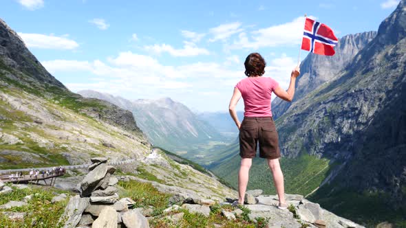 Tourist With Norwegian Flag On Trollstigen Area