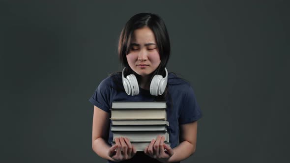 Asian Student Is Dissatisfied Wit Homework books.Girl with Books, She Is Annoyed