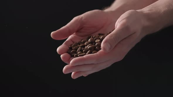 Slow Motion Mam Pour Coffee Beans Over Balck Background