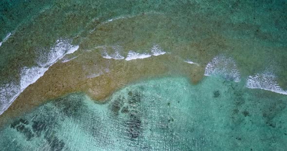 Beautiful aerial abstract shot of a sandy white paradise beach and aqua blue water background in colourful