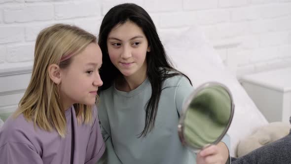 Friends Putting Makeup on Together in the Bathroom