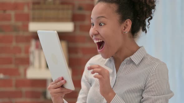 Portrait of African American Woman Celebrating on Tablet