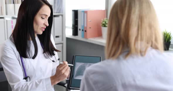 Woman Doctor Showing Xray of Lungs on Digital Tablet to Patient  Movie Slow Motion