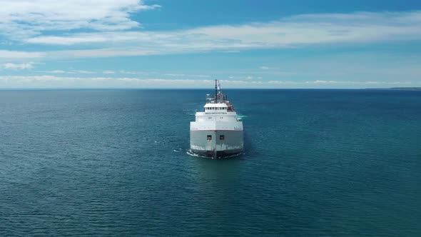 Aerial view straight on of lake freighter on Superior near Duluth, Minnesota - ascending drone shot