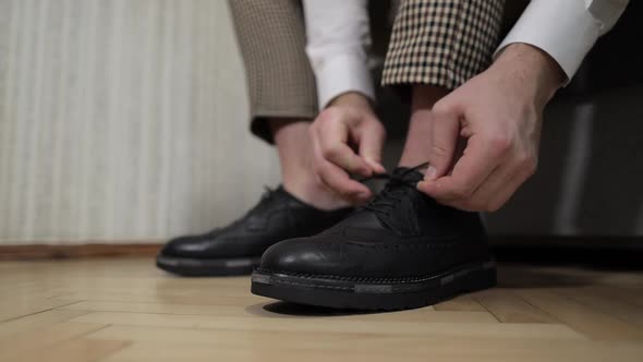 Groom Putting His Wedding Shoes on Wedding Day. Hands of Wedding Groom