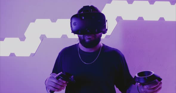 Man Playing VR Games. A New Reality. Neon Lighting. Footage with the Effect of Film, Grain