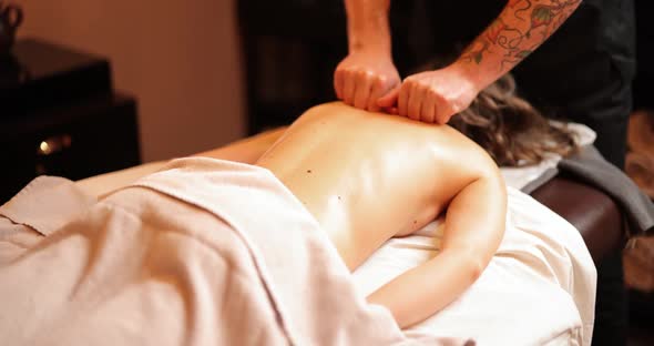 Woman Receiving Back Massage in Spa