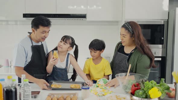 Happy family mom dad and kids siblings cooking together.