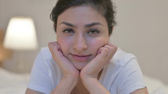 Portrait of Young Indian Woman Looking at the Camera in Bedroom