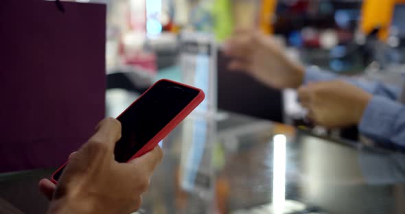 Young muslim man paying by scanning QR Code with smartphone