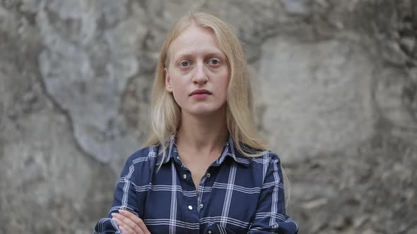 Portrait of Self Confident Woman in Blue Shirt Looking To Camera and Crossing Arms. Crop View of