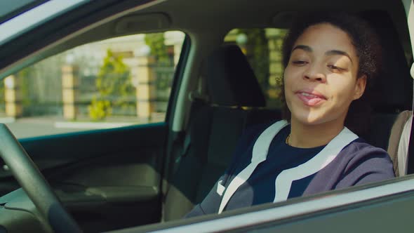 Excited Woman Receiving Keys of New Car From Dealer