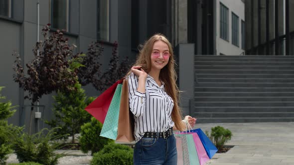 Girl Walking with Colorful Shopping Bags, Rejoicing Discounts in Fashion Store, Enjoying Shopping