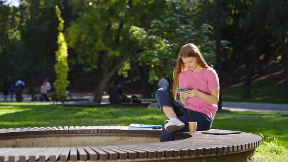 Woman Browsing Social Media on Smartphone Outside