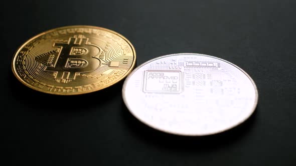 Golden and Silver Bitcoin Coins on Black
