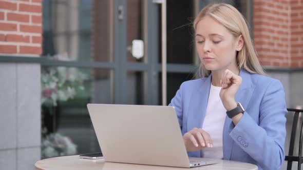 Thinking Young Businesswoman Sitting Outdoor