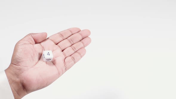 Hand Holds Numbered Dice Four