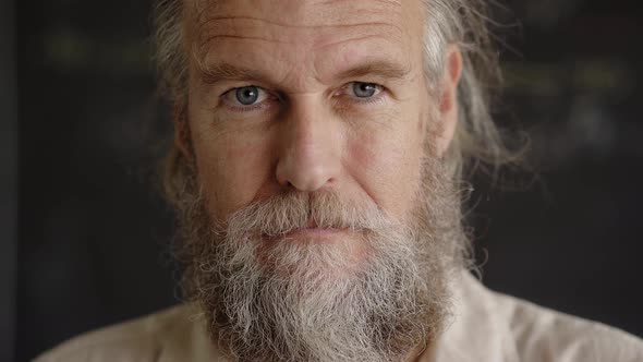 Close Up Portrait of a Handsome Middleaged Man Looking at Camera with an Intense Gaze