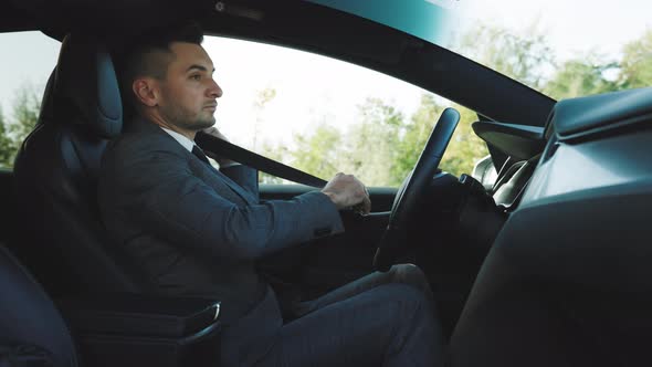 Man Fastens Car Seat Belt With Hand