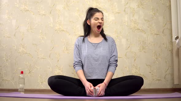 Young Lazy Woman Yawning Doing Start Stretching Exercise on Rag Yoga Practice