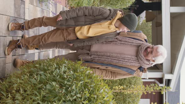 Grandfather and His Grandson Standing in Garden