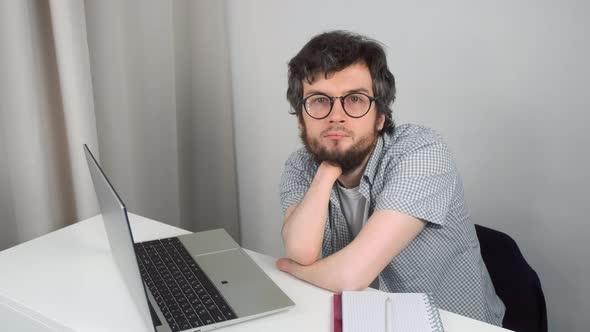 Portrait of Disabled Man with Amputated Two Stump Hands Studying on Laptop