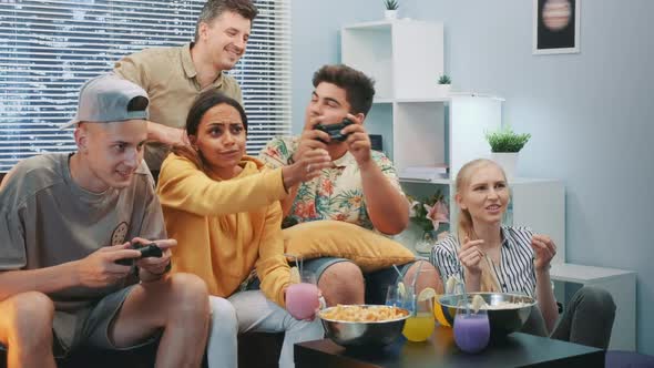 Close Up of Two Guys Playing Video Console Game, One of Them Wins