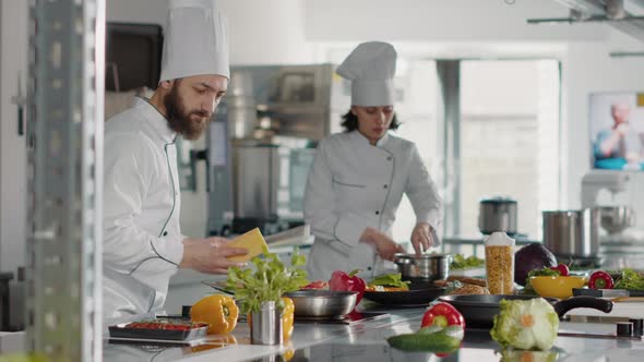 Authentic Cook Grating Parmesan Cheese on Gourmet Dish