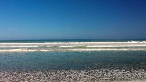 WIde shot of incoming waves on a sunny day - Truck shot