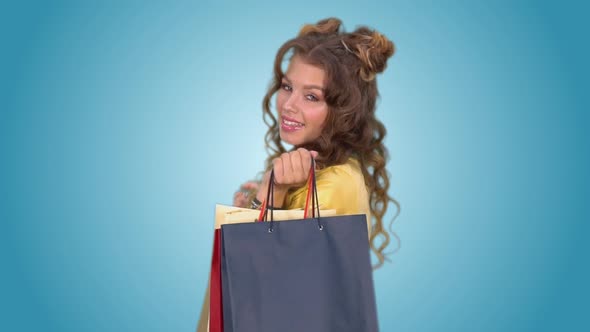 Attractive Girl Posing Holding Shopping Bags in Her Hands